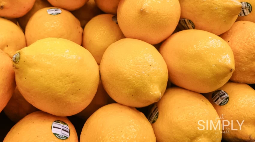 Close-up of fresh lemons piled together at a grocery store.