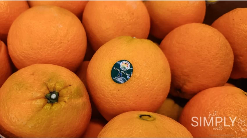 Close-up of a pile of fresh naval oranges at a grocery store